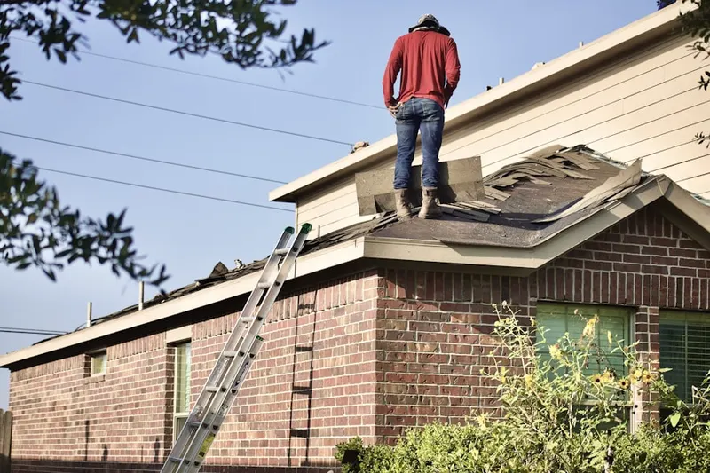Professional roofer working on a residential roof in Spice Ranch